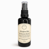 Black spray bottle labeled 'Afterglow Mist' on a white background