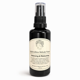 Black bottle of Aphrodites Melody Toner with a white label on a white background