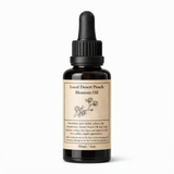 Bottle of Local Desert Peach Blossom Oil with a dropper on a white background
