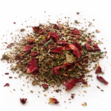 Heap of dried herbs and spices (Magic Women: Herbal Tea Blend) on a white background