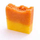Two-tone orange and yellow soap bar (Sheelite's Grapefruit Sage Soap) on a white background