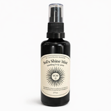 Black spray bottle labeled 'Sol's Shine Mist' on a white background