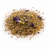 Heap of dried herbs and flowers (The Catalyst: Green Tea Blend) on a white background