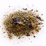 Heap of dried herbs and flowers (The Catalyst: Black Tea Blend) on a white background